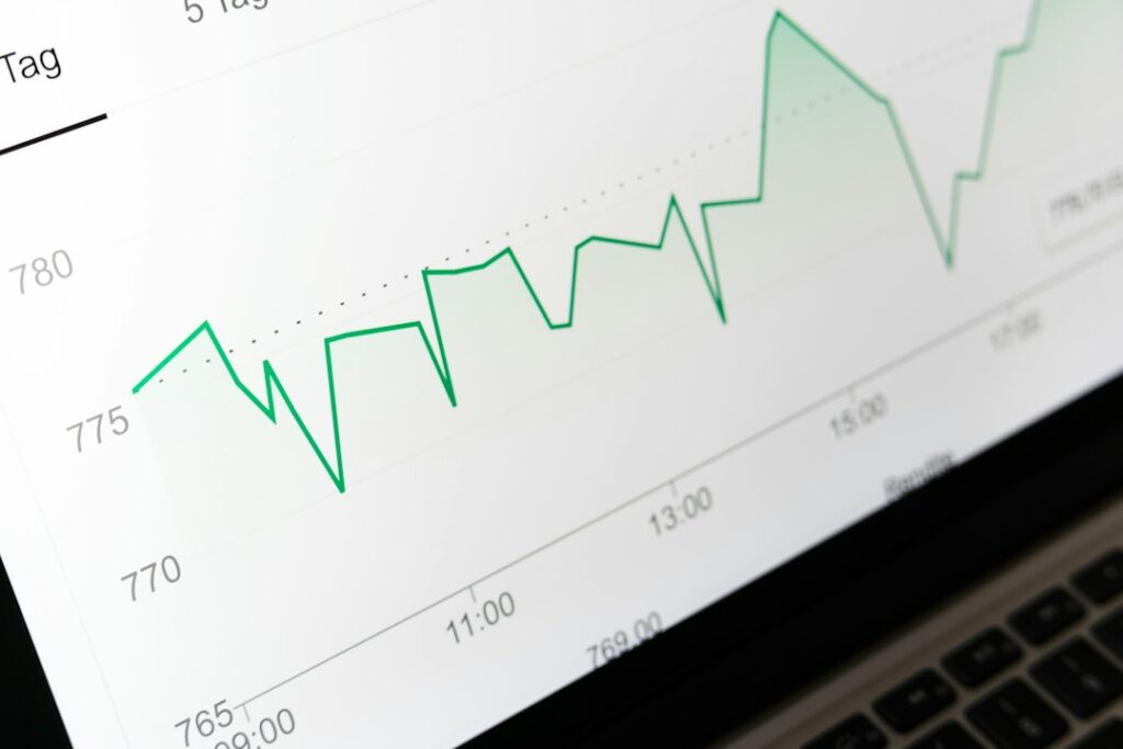 Upward trending analytics chart on a screen representing compounding SEO results over 7 to 12 months