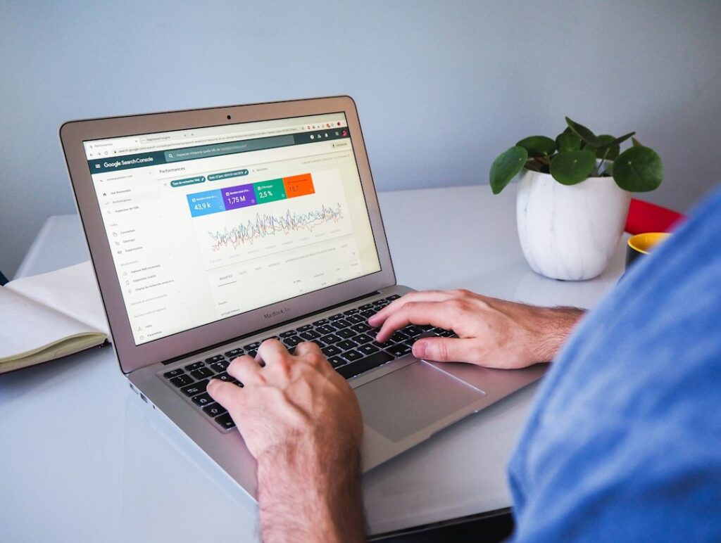 Person reviewing Google Search Console data on a laptop to track SEO performance