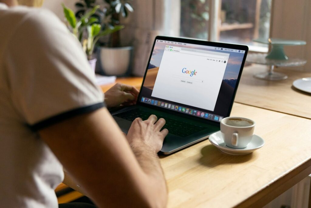 Business owner searching Google on a laptop during the early months of an SEO campaign